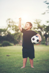 Little Boy playing soccer football