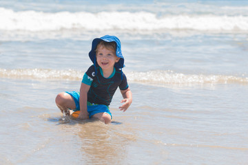 Young Boy on Beach Playing in the Ocean