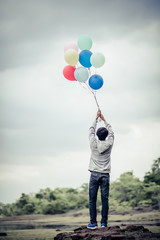 Young man hand holding colorful balloons © Johnstocker