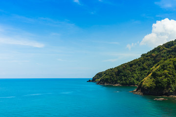 Fototapeta na wymiar Summer seascape view with clear sea, green forest and blue sky on koh Lanta island in Thailand.