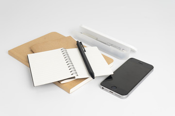 Stationery set such as Note books ,Pen and Smartphone on white background.