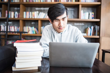 Young student man tired of computer sitting at cafe table with laptop