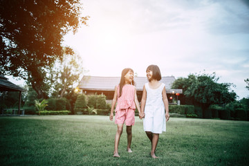 Fototapeta premium Two little girls friends playing funny in the park