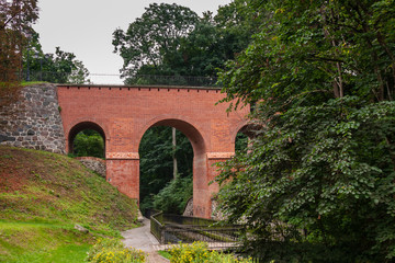 Fototapeta na wymiar an old brick bridge with arches
