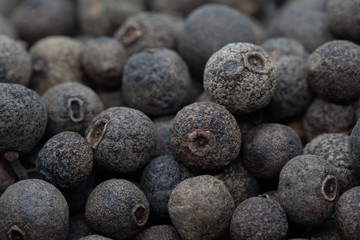 Pile of whole black pepper seeds