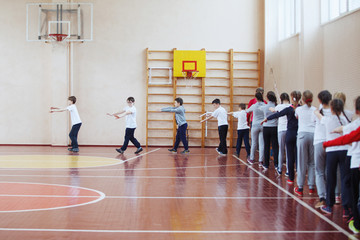 Primary school children a sport lesson indoors