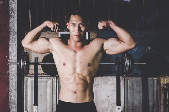 Strong Athletic Man showing muscel in local gym