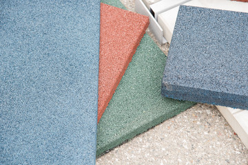 Modern floor covering in the form of rubber tiles of red, green and blue