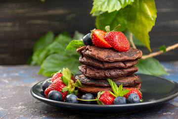Chocolate pancakes with berries