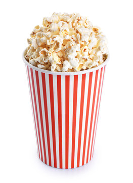 Popcorn in striped bucket isolated on a white background.