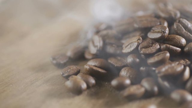 Fried coffee beans, delicious aroma, covered with smoke, roasted grain cafe flavor taste hot fresh smell morning.