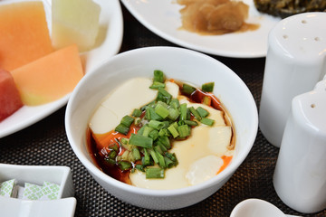 Tofu with  soya sauce on white bowl