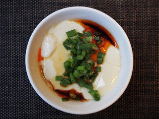 Tofu with  soya sauce on white bowl