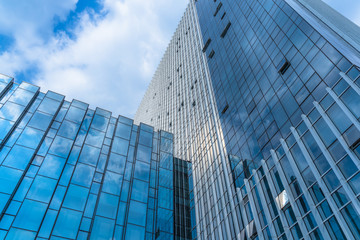 Fototapeta na wymiar Clouds Reflected in Windows of Modern Office Building.