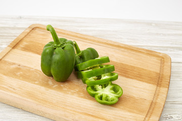 paprika green on wooden cutting board