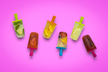 Homemade fruit popsicle on a pink background. Strawberry, Lemon, Lemon with mint, Orange, Cherry, Multifruit. Flat lay, top view
