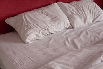 Fototapeta na wymiar Messy bed sheets and pillow
