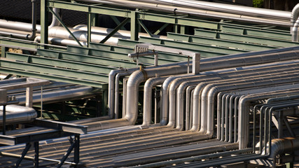 Close up equipment, cables and piping as found inside of industrial petrochemical , Oil refinery plant .