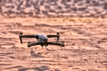 Fototapeta na wymiar The Drone flying over the desert .