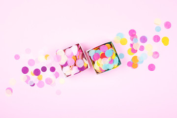 Two boxes with colorful confetti on pink background. Festive banner. Top view.