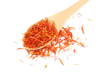 Heap of saffron in wooden spoon isolated on white background. Top view. Flat lay