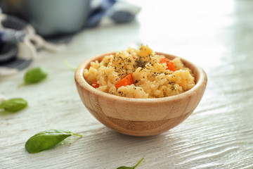 Bowl with delicious pumpkin risotto on wooden table