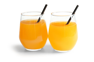 Glasses of tangerine juice on white background
