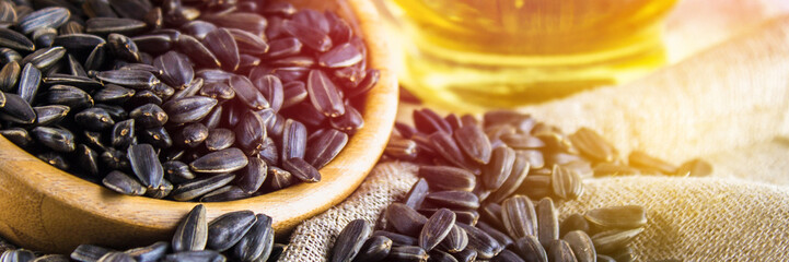 Sunflower seed and oils on wooden table.