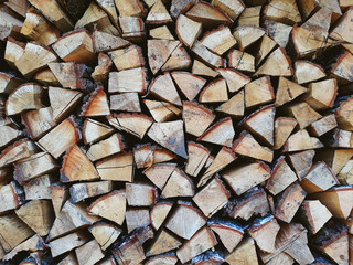Firewood background, wall firewood, background of dry chopped firewood logs in a pile