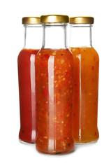 Bottles with tasty sauces on white background