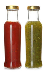 Bottles with tasty sauces on white background