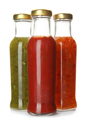 Bottles with tasty sauces on white background