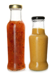 Bottles with tasty sauces on white background