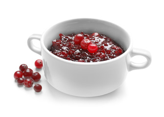 Bowl with tasty cranberry sauce on white background