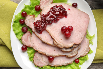 Tasty dish served with cranberry sauce on plate, top view