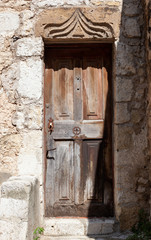 Old wooden door and stone details in Eze, France