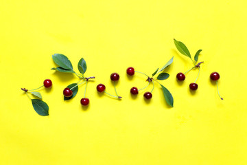 Cherry berries on a yellow background . ..
