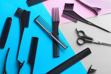 Naklejka premium Flat lay composition with set of hairdresser's tools on color background