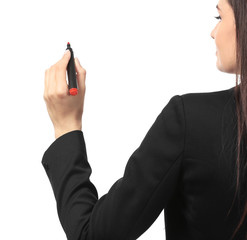 Young businesswoman writing on white background