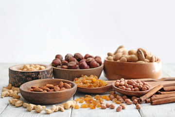 Different kinds of nuts and raisins on table