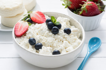 Curd cheese, farmer cheese, tvorog or quark fresh berries in a bowl. Healthy lifestyle, healthy eating food