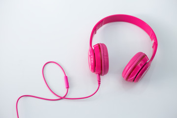 Pink headphones on a white background.