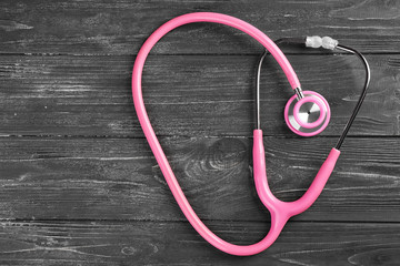 Stethoscope on dark wooden background