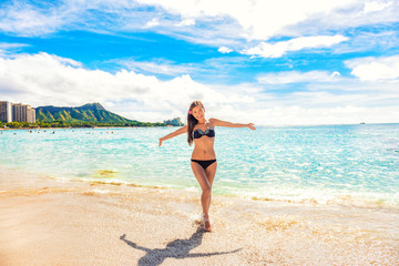 Fototapeta na wymiar Summer vacation carefree joyful sun woman with open arms in success enjoying body weight loss tropical beach destination. Holiday bikini girl relaxingon Hawaii beach Waikiki vacation.