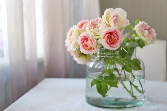Beautiful bouquet of white and pink roses in the glass. Summer mood