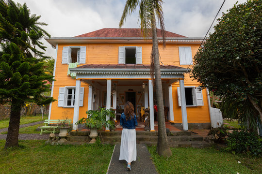 Girl in front of a case creole in Hell Bourg, Reunion Island