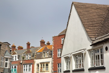 Fototapeta na wymiar Close-up on traditional houses with brickstone and flagstone roofs in Swanage, Isle of Purbeck, Dorset, UK