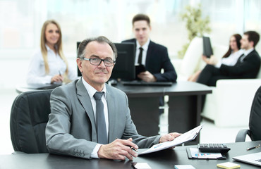 experienced businessman working with financial documents office