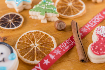 wooden chopping board with christmas holiday cookis gingerbread background 