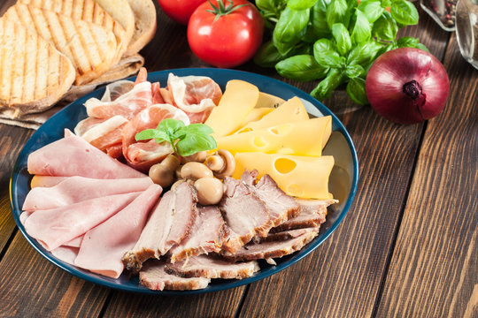 Cold meat platter with ham, prosciutto, bacon and cheese